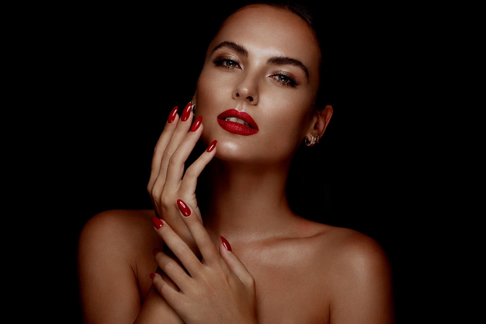 Beautiful Girl with a Classic Make-up and Red Nails. Manicure Design. Beauty Face.